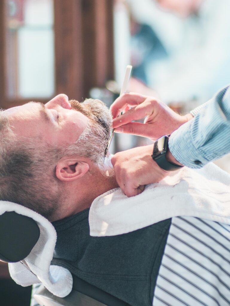 Premium Barber Services in Flagstaff Arizona, A Man Is Getting a beard shaping At The Urban Shave Flagstaff