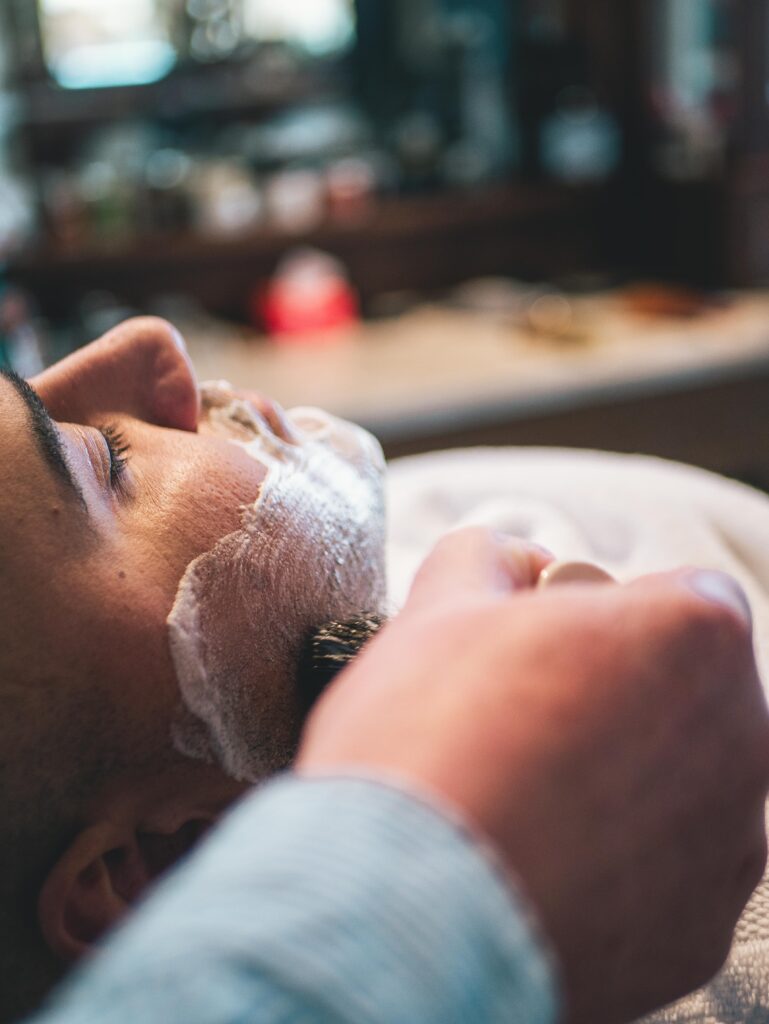 Premium Barber Services in Flagstaff Arizona, A Man Is Getting a hot towel shave At The Urban Shave Flagstaff