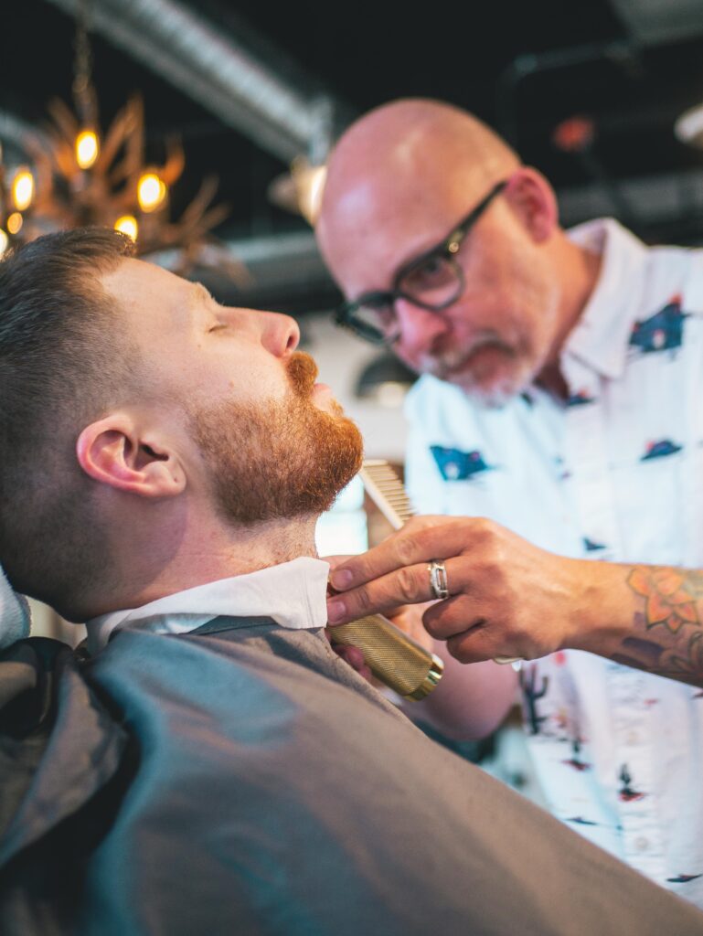 Premium Barber Services in Flagstaff Arizona, A Man Is Getting a Hair Cut and beard shaping At The Urban Shave